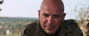 Movie still from “Kelly's Heroes” (1970), directed by Brian G. Hutton – A man with a bald head is looking at the camera; Close Up shot, Low angle