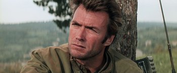 Movie still from “Kelly's Heroes” (1970), directed by Brian G. Hutton – A man with a goatee is sitting in front of a tree; Close Up shot, Low angle