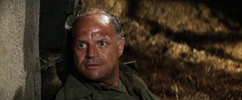 Movie still from “Kelly's Heroes” (1970), directed by Brian G. Hutton – A person with a rifle; Close Up shot, High angle