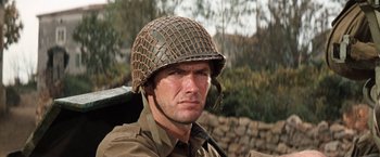 Movie still from “Kelly's Heroes” (1970), directed by Brian G. Hutton – A man wearing a helmet and a uniform; Close Up shot, Low angle
