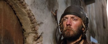 Movie still from “Kelly's Heroes” (1970), directed by Brian G. Hutton – A man with a beard wearing a black hat; Close Up shot, Low angle