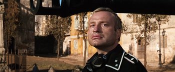 Movie still from “Kelly's Heroes” (1970), directed by Brian G. Hutton – A person wearing a police uniform; Close Up shot, Low angle