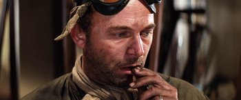 Movie still from “Kelly's Heroes” (1970), directed by Brian G. Hutton – A person smoking a cigarette; Close Up shot, Low angle