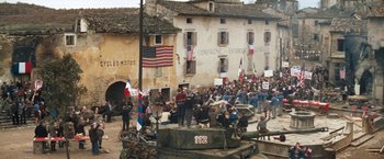 Movie still from “Kelly's Heroes” (1970), directed by Brian G. Hutton – A crowd of people gathered around a tank; Extreme Wide shot, High angle