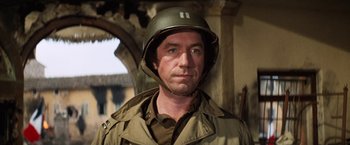 Movie still from “Kelly's Heroes” (1970), directed by Brian G. Hutton – A man wearing a military uniform and a helmet; Close Up shot, Low angle