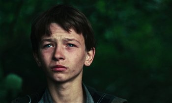 Movie still from “Kes” (1969), directed by Ken Loach – A young man with a sad look on his face; Close Up shot, Low angle