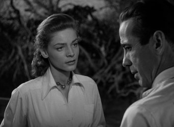 Movie still from “Key Largo” (1948), directed by John Huston – A man and a woman talking to each other; Close Up shot, Over the shoulder angle