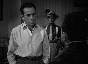 Movie still from “Key Largo” (1948), directed by John Huston – A black - and - white photo of a man and a woman; Medium shot, Over the shoulder angle
