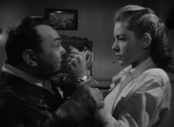 Movie still from “Key Largo” (1948), directed by John Huston – A man and a woman fighting in a living room; Close Up shot, High angle