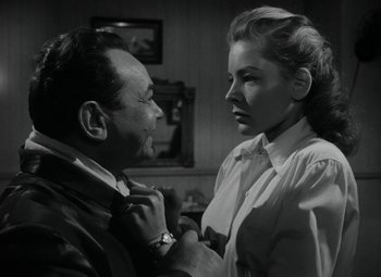Movie still from “Key Largo” (1948), directed by John Huston – A man and a woman looking at one another; Close Up shot, Low angle