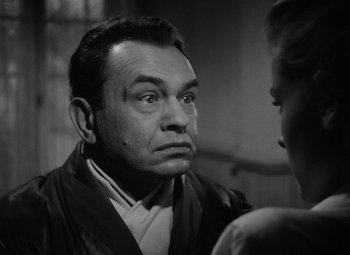 Movie still from “Key Largo” (1948), directed by John Huston – An old photo of a man looking at a woman; Close Up shot, Over the shoulder angle