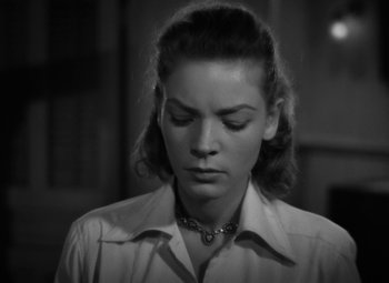 Movie still from “Key Largo” (1948), directed by John Huston – A black - and - white photo of a woman in a dress shirt; Close Up shot, High angle