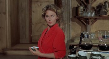 Movie still from “Kid Galahad” (1962), directed by Phil Karlson – A woman in a red jacket holding a cup; Medium shot, Low angle