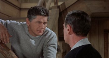 Movie still from “Kid Galahad” (1962), directed by Phil Karlson – A man talking to another man in front of a mirror; Close Up shot, Over the shoulder angle