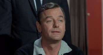 Movie still from “Kid Galahad” (1962), directed by Phil Karlson – A person wearing a suit and tie; Close Up shot, Low angle