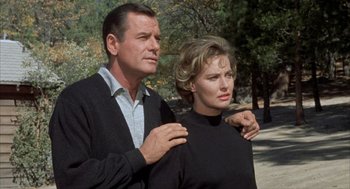 Movie still from “Kid Galahad” (1962), directed by Phil Karlson – A man and a woman standing next to each other on a street; Medium shot, Low angle
