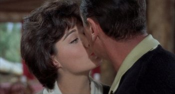 Movie still from “Kid Galahad” (1962), directed by Phil Karlson – A man and a woman kissing each other in front of a mirror; Close Up shot, Over the shoulder angle