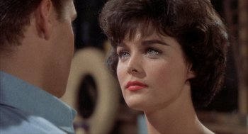 Movie still from “Kid Galahad” (1962), directed by Phil Karlson – A woman's face as a man looks on; Close Up shot, Over the shoulder angle