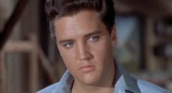 Movie still from “Kid Galahad” (1962), directed by Phil Karlson – A person wearing a blue shirt; Close Up shot, Low angle