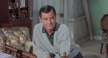 Movie still from “Kid Galahad” (1962), directed by Phil Karlson – A person sitting on a couch; Close Up shot, Low angle