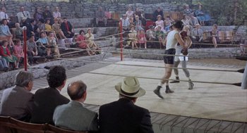 Movie still from “Kid Galahad” (1962), directed by Phil Karlson – Spectators watching a boxing match in a boxing ring; Wide shot, High angle