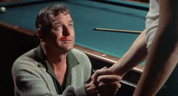 Movie still from “Kid Galahad” (1962), directed by Phil Karlson – A man in a pool hall shaking hands with another man; Close Up shot, Over the shoulder angle