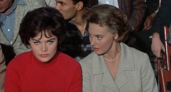 Movie still from “Kid Galahad” (1962), directed by Phil Karlson – Two women sitting next to each other in a room; Close Up shot, Over the shoulder angle