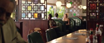 Movie still from “Kidnap” (2017), directed by Luis Prieto – A group of people sitting at a booth in a restaurant; Wide shot, Over the shoulder angle