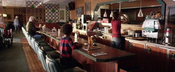 Movie still from “Kidnap” (2017), directed by Luis Prieto – Two people at a counter in a restaurant; Wide shot, Over the shoulder angle