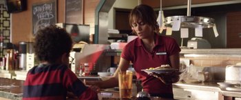 Movie still from “Kidnap” (2017), directed by Luis Prieto – A woman sitting at a table in front of food; Medium shot, Over the shoulder angle