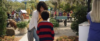 Movie still from “Kidnap” (2017), directed by Luis Prieto – A woman and a boy are talking in a park; Medium shot, Over the shoulder angle