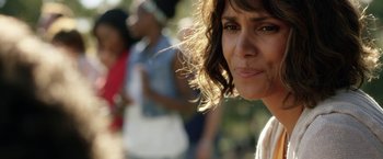 Movie still from “Kidnap” (2017), directed by Luis Prieto – A woman's face in a crowd; Close Up shot, Over the shoulder angle
