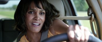 Movie still from “Kidnap” (2017), directed by Luis Prieto – A person in a car holding a steering wheel; Close Up shot, Over the shoulder angle