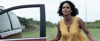 Movie still from “Kidnap” (2017), directed by Luis Prieto – A woman standing next to a television outside; Close Up shot, Low angle