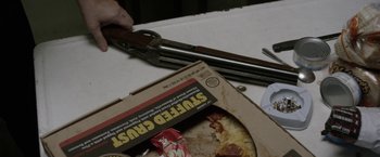 Movie still from “Kidnap” (2017), directed by Luis Prieto – A box of pizza with a knife in the background; Extreme Close Up shot, High angle