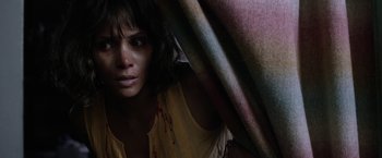 Movie still from “Kidnap” (2017), directed by Luis Prieto – A woman with a yellow shirt is hiding behind a blanket; Close Up shot, High angle