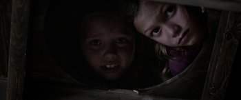 Movie still from “Kidnap” (2017), directed by Luis Prieto – Two young children looking at the camera in the dark; Close Up shot, Low angle