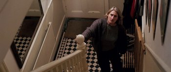 Movie still from “Kidulthood” (2006), directed by Menhaj Huda – A woman reaching down a flight of stairs; Medium shot, High angle