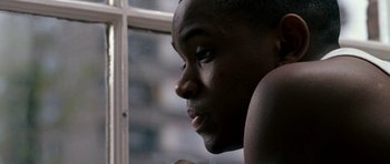 Movie still from “Kidulthood” (2006), directed by Menhaj Huda – A person looking out of a window; Close Up shot, Low angle