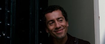 Movie still from “Kidulthood” (2006), directed by Menhaj Huda – A person with curly hair smiling; Close Up shot, Low angle