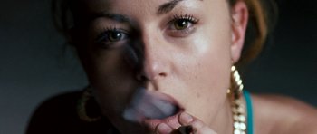 Movie still from “Kidulthood” (2006), directed by Menhaj Huda – A person smoking a cigarette; Extreme Close Up shot, Overhead angle