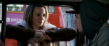 Movie still from “Kidulthood” (2006), directed by Menhaj Huda – A young woman holding onto the side of a car window; Close Up shot, Over the shoulder angle