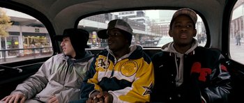 Movie still from “Kidulthood” (2006), directed by Menhaj Huda – A group of young men riding in a car; Medium shot, Over the shoulder angle
