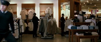 Movie still from “Kidulthood” (2006), directed by Menhaj Huda – Two women are shopping in a clothing store; Wide shot, Over the shoulder angle