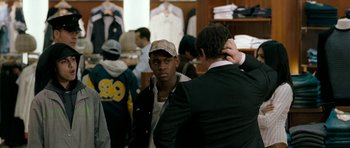 Movie still from “Kidulthood” (2006), directed by Menhaj Huda – A man in a hat is talking to another man in a suit; Medium shot, Over the shoulder angle