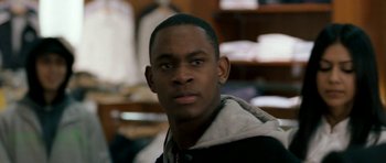 Movie still from “Kidulthood” (2006), directed by Menhaj Huda – A person wearing a jacket; Close Up shot, Over the shoulder angle