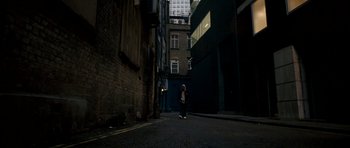 Movie still from “Kidulthood” (2006), directed by Menhaj Huda – A person walking down a street near a building; Wide shot, Low angle
