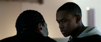 Movie still from “Kidulthood” (2006), directed by Menhaj Huda – Two men face each other in a room; Close Up shot, Over the shoulder angle