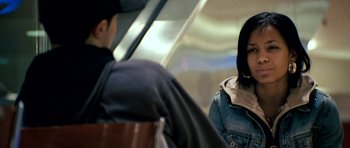 Movie still from “Kidulthood” (2006), directed by Menhaj Huda – A man and a woman are sitting on a bench; Close Up shot, Over the shoulder angle