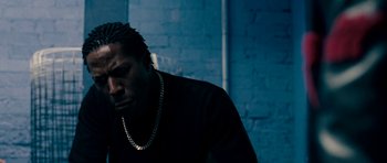 Movie still from “Kidulthood” (2006), directed by Menhaj Huda – A person wearing a necklace; Close Up shot, Low angle